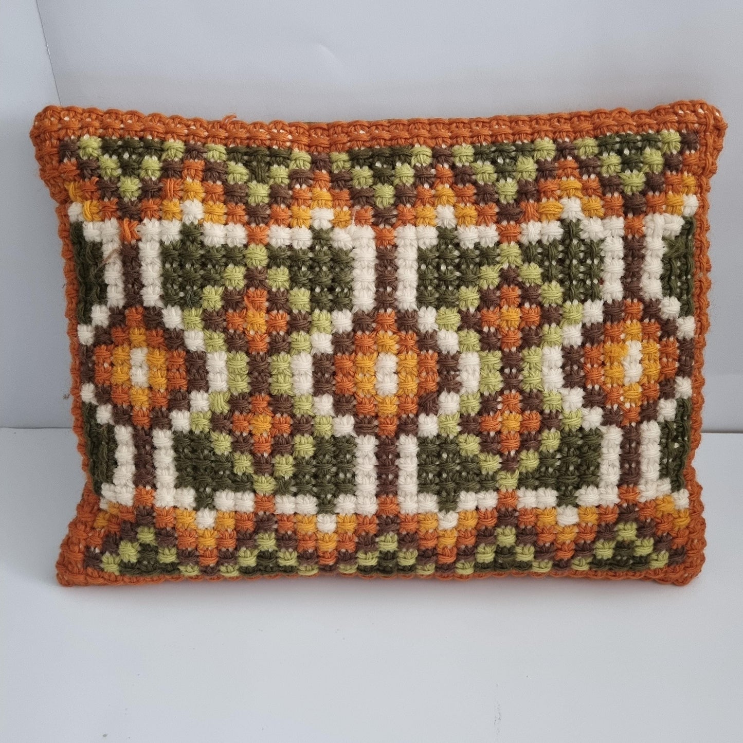 Vintage hand embroidered cushion with geometric pattern.