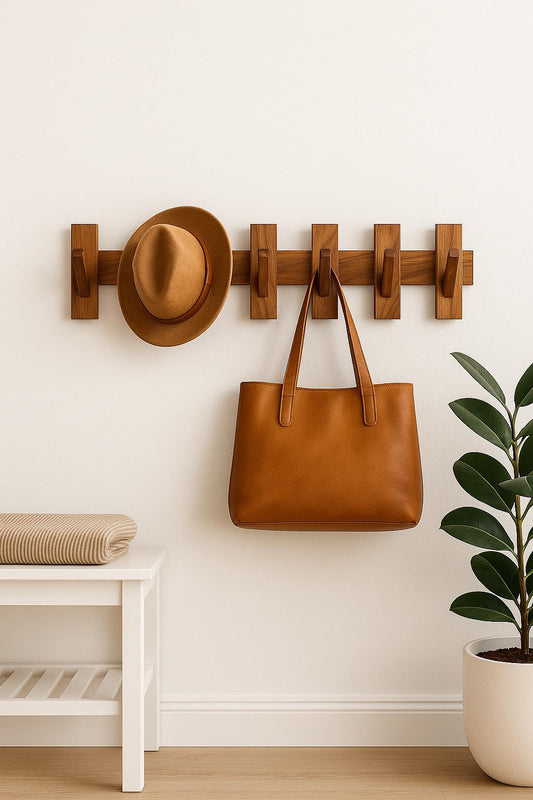 Modular Teak Wall Coat Rack: Scandinavian Entryway Organizer holding a hat and tan leather bag in minimalist space