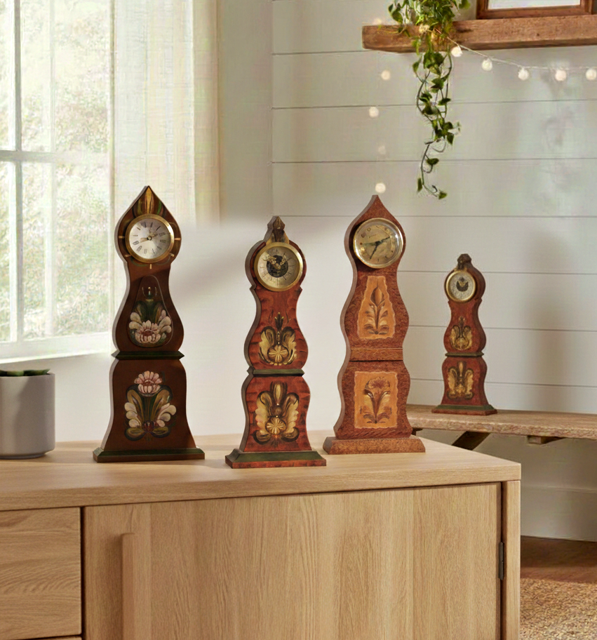 Four Vintage Swedish Mora Wooden Table Clocks – Hand-Painted Folk Art with authentic vintage Scandinavian charm on wooden cabinet.