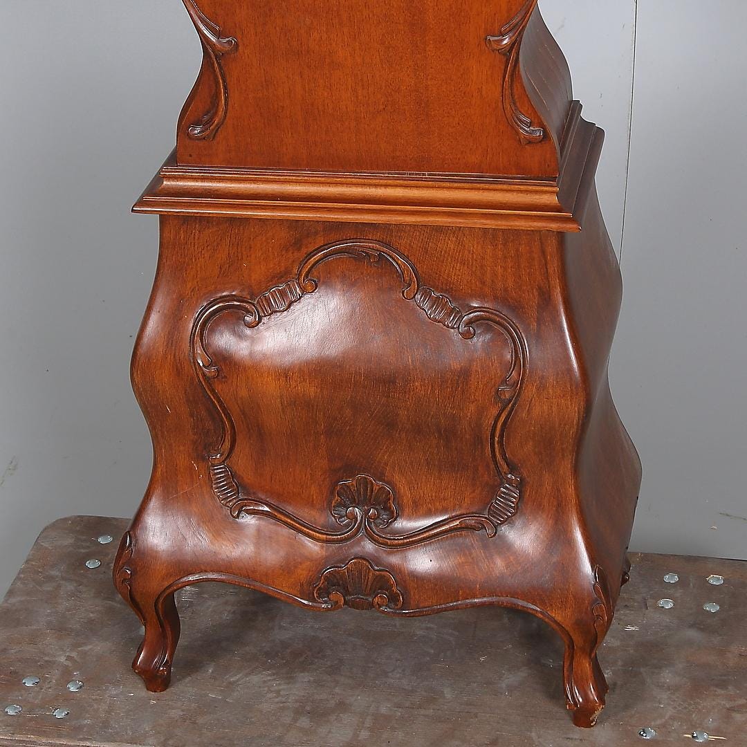 Base of Grandfather Clock ,Elegant Vintage Floor Clock with ornate carved wooden details and curved legs.