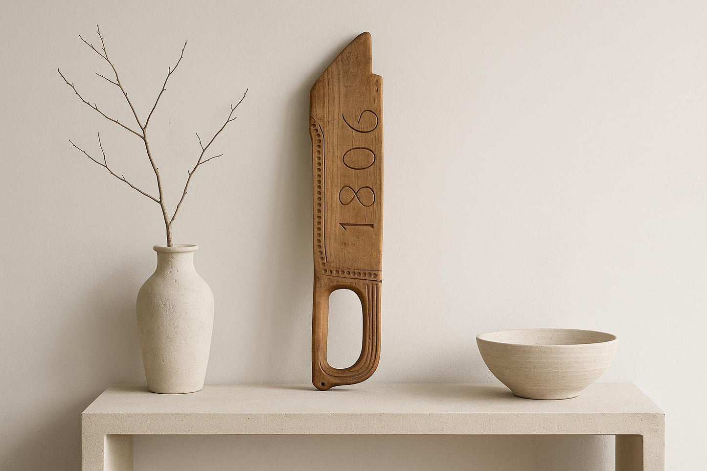 Antique Hand-Carved Butter Paddle: 1806 Scandinavian Folk Art Decor displayed with minimalist ceramic vase and bowl.