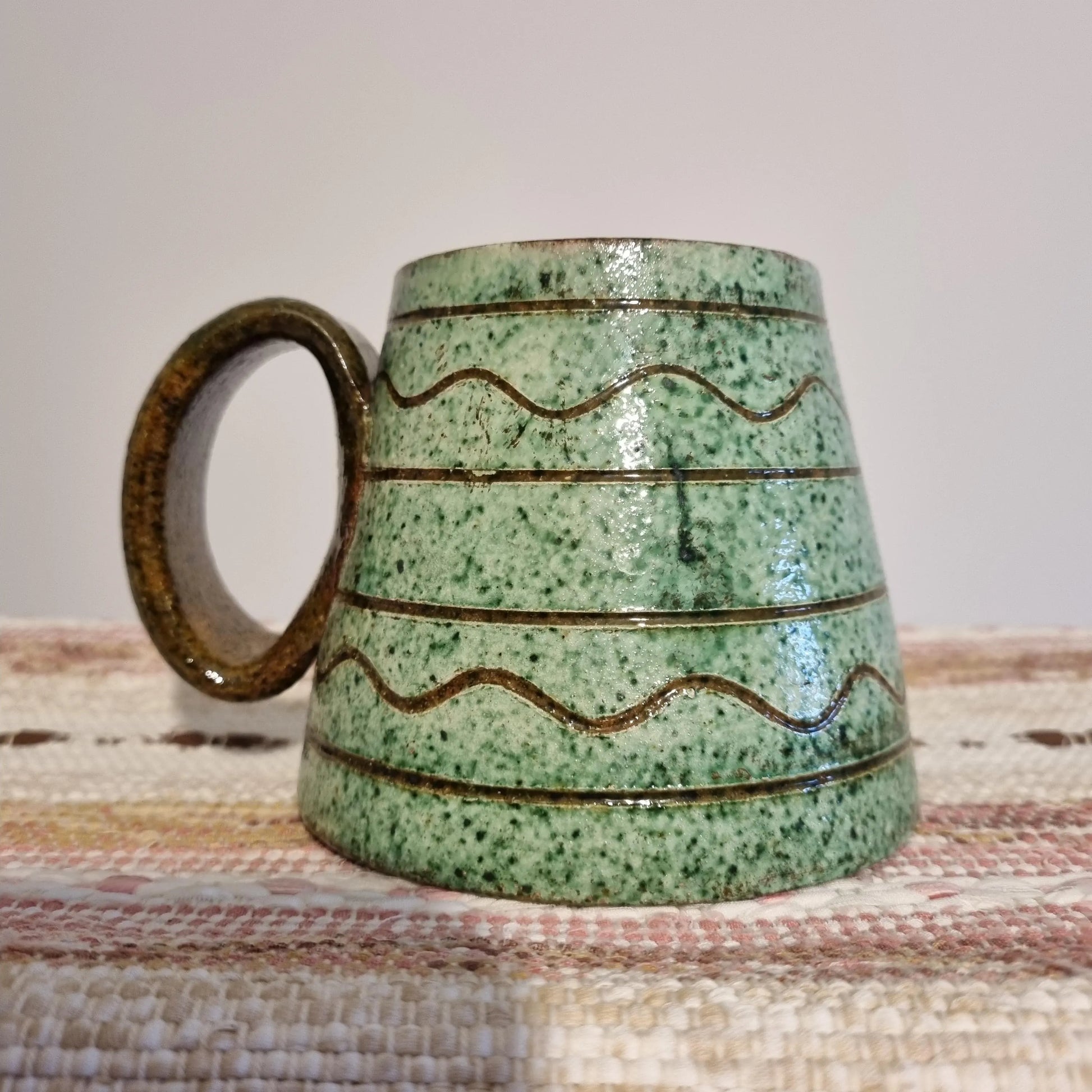 Krukmakeri Ystad Swedish Stoneware Mug – Speckled Green Glaze, Handmade with wavy line patterns and rustic handle