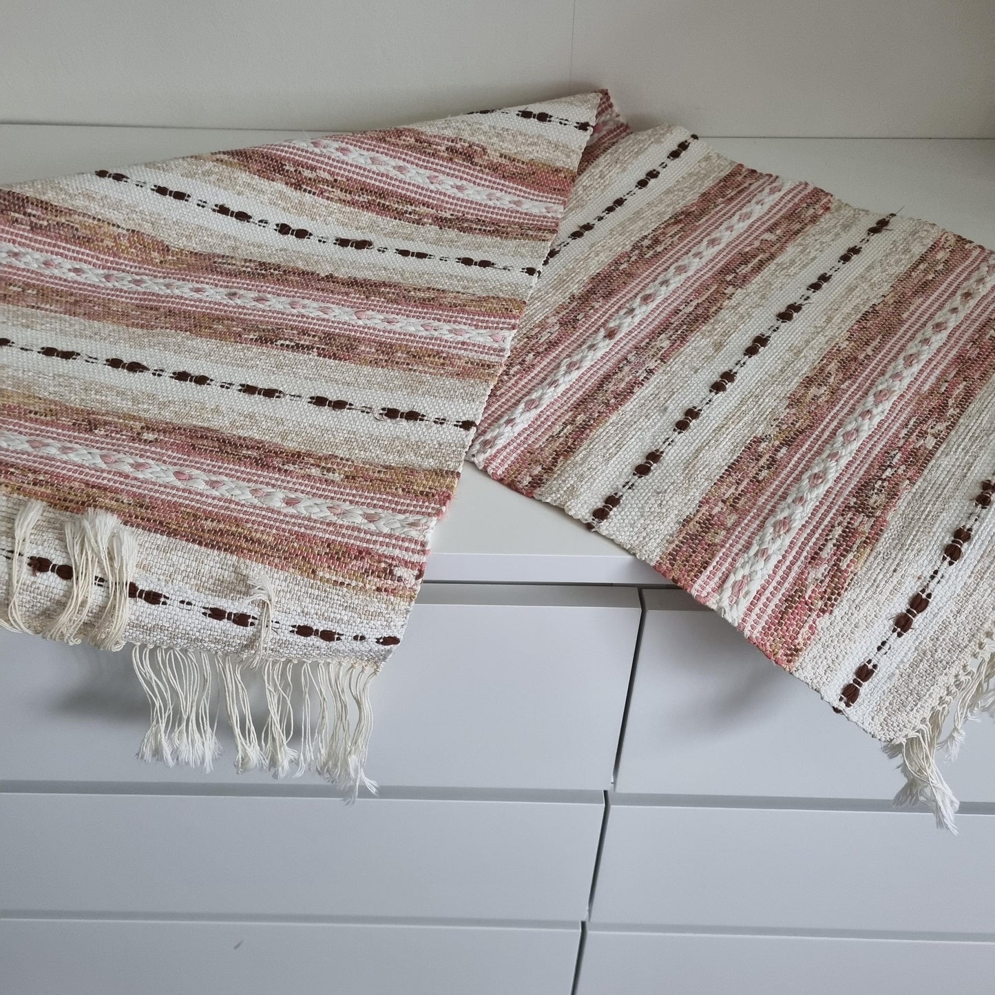 Handwoven Swedish Table Runner: Scandi Boho Pastel Decor Rug with soft pink, white, and brown stripes and fringed edges.