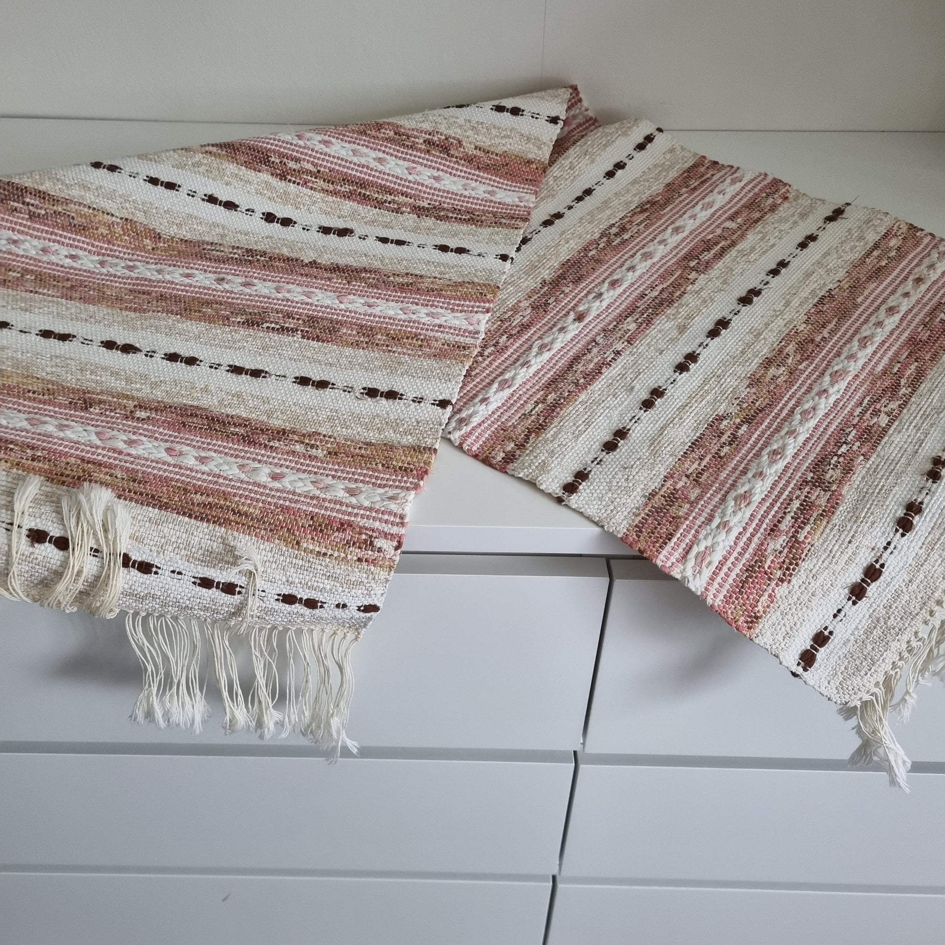 Handwoven Swedish Table Runner: Scandi Boho Pastel Decor Rug with soft pink, white, and brown stripes and fringed edges.