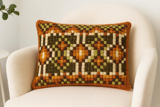 Vintage hand embroidered cushion with geometric pattern.