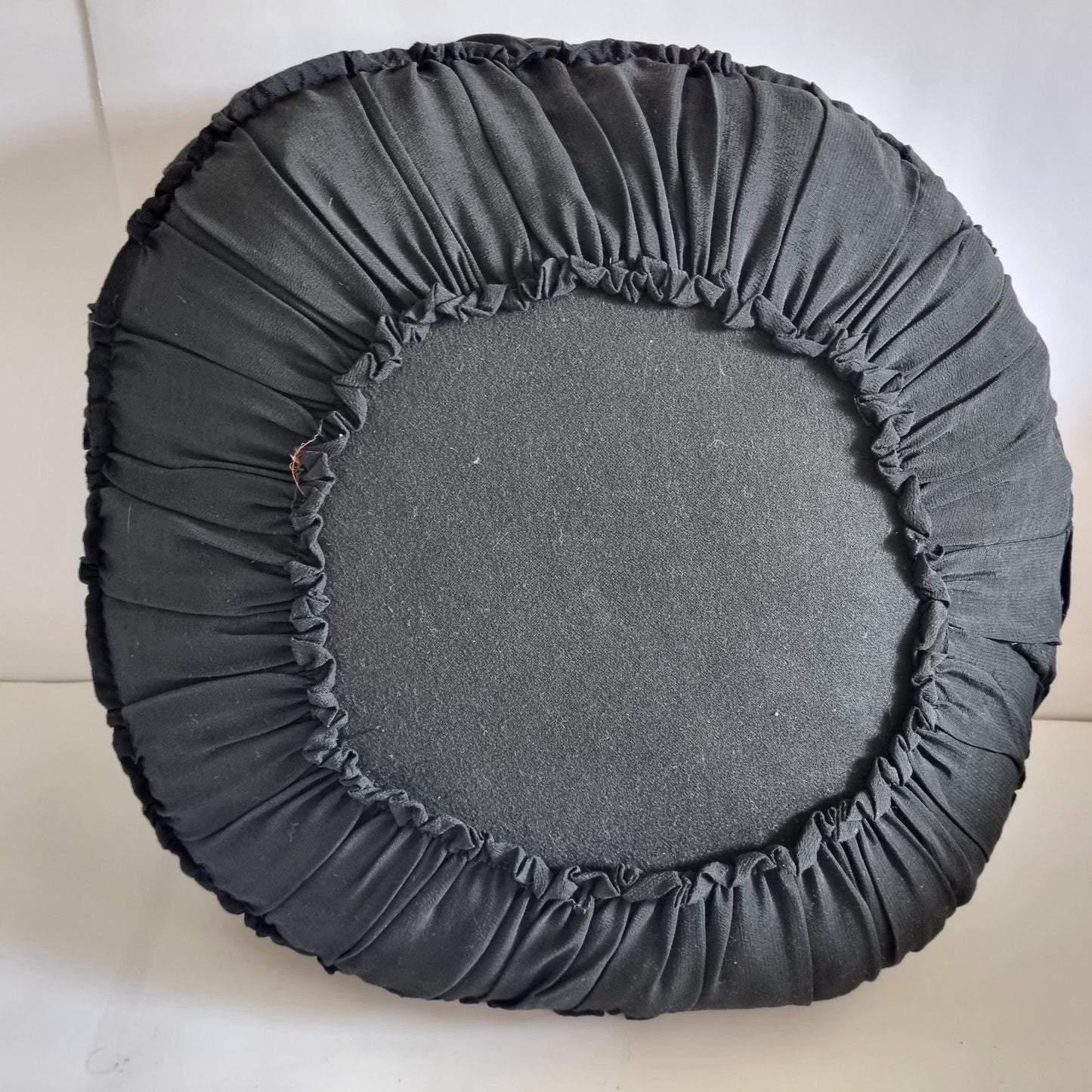 Vintage Embroidered Floral Throw Pillow: Black Ruffled Cushion shown from the back with gathered fabric detailing