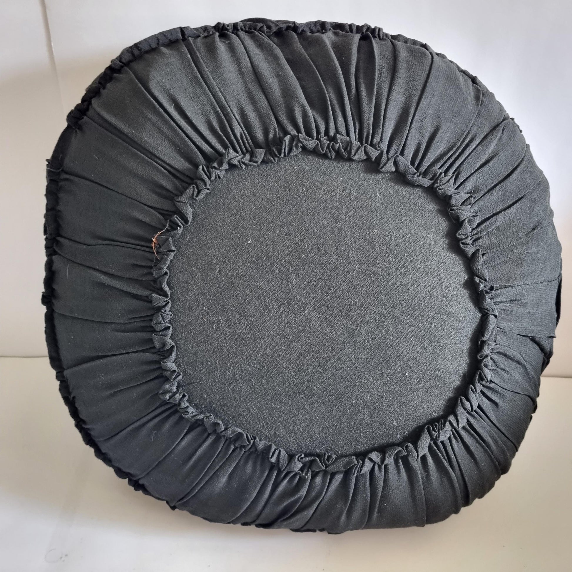 Vintage Embroidered Floral Throw Pillow: Black Ruffled Cushion shown from the back with gathered fabric detailing
