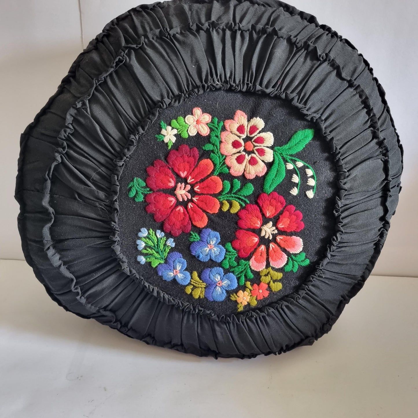 Vintage Embroidered Floral Throw Pillow: Black Ruffled Cushion with colorful floral embroidery and gathered fabric edge