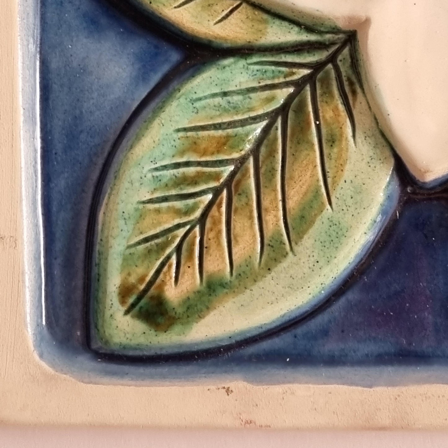 Swedish Ceramic Wall Plaque – Handcrafted Floral Relief, Signed, Mid-Century featuring detailed green leaf on blue background