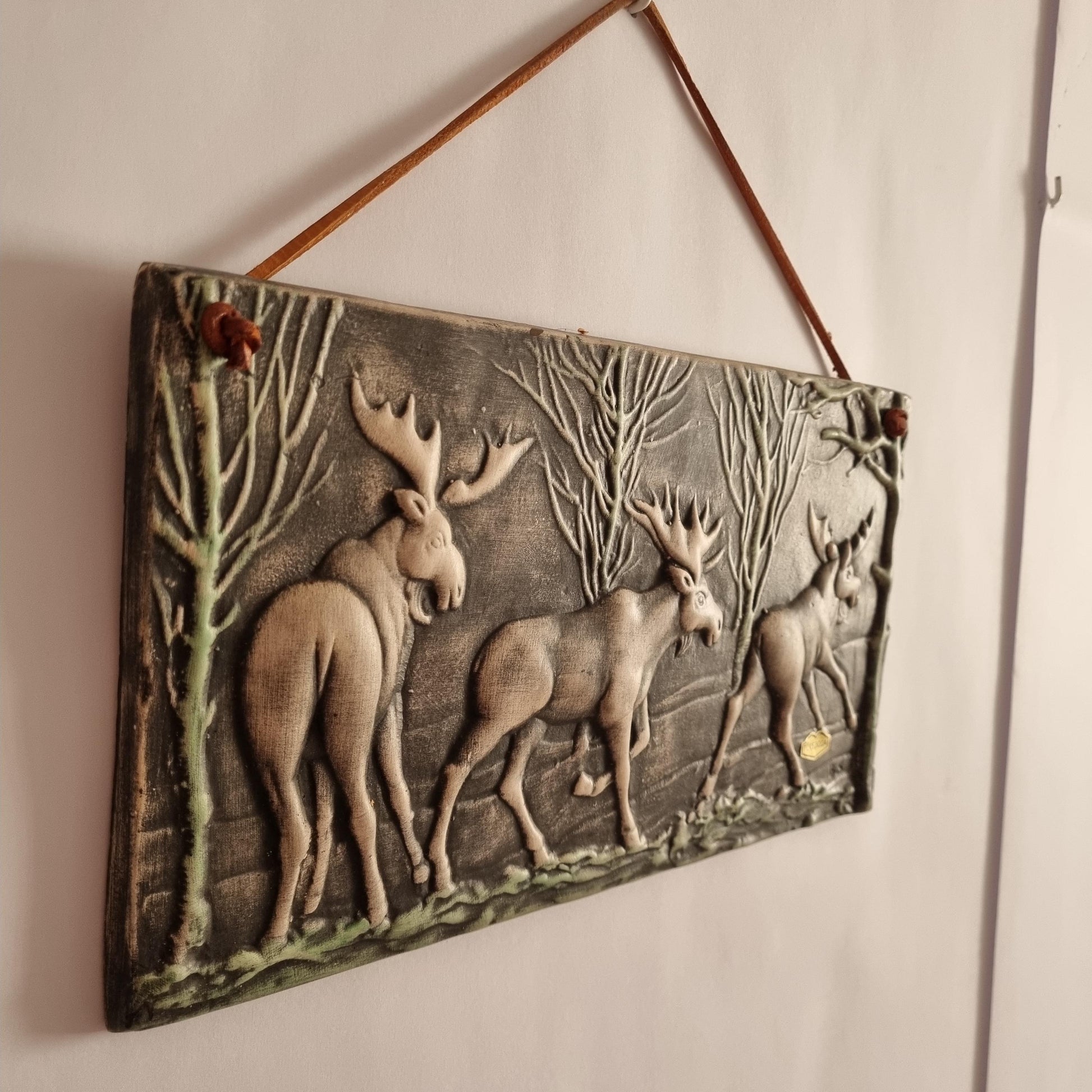 Toreboda Swedish Ceramic Wall Plaque – Moose Forest Relief, Mid-Century showcasing three moose in a textured forest scene hanging on wall