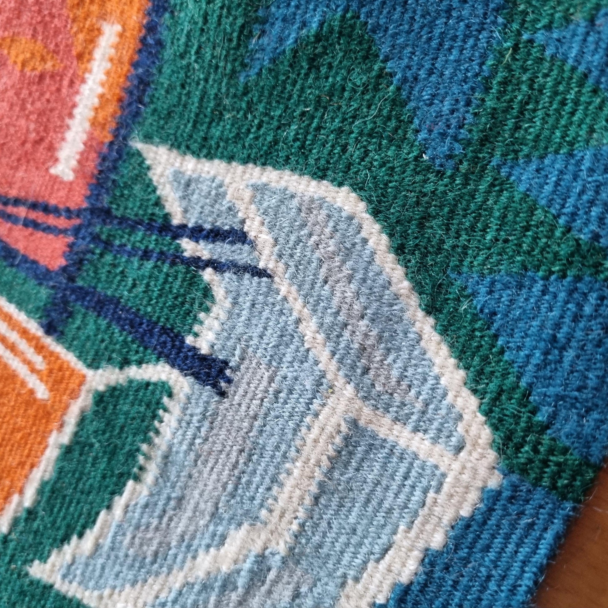 Close-up detail of woven texture on Vintage Viking Ship Tapestry | 1970s Mid-Century Modern Woven Wall Art with vibrant colors.