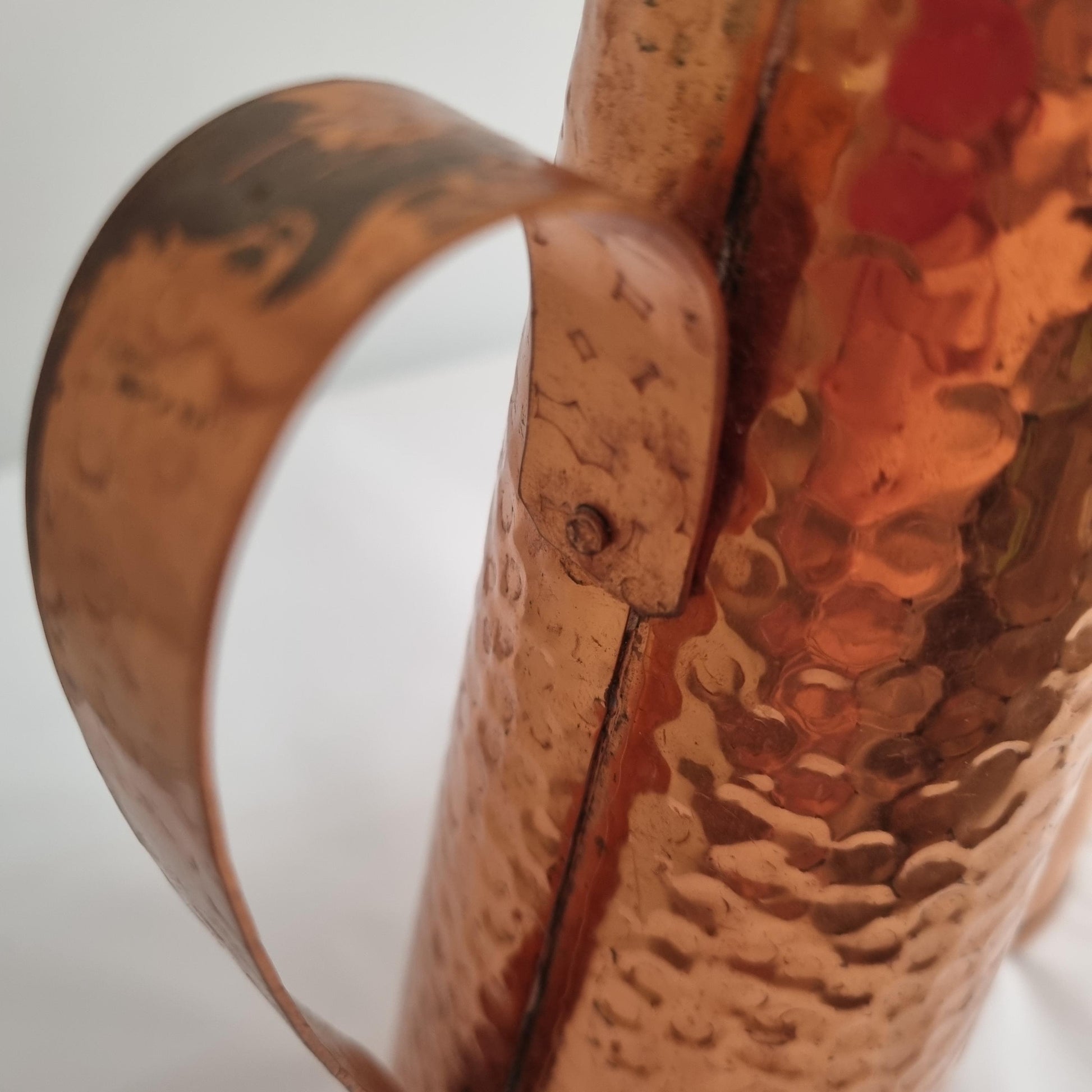 Close-up of the hammered copper texture and handle on Mid Century Modern Hammered Copper Jug: Swedish Vase, 1960s MCM Decor