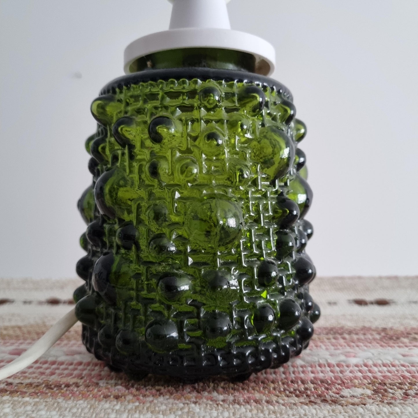 Mid-Century Modern Art Glass Table Lamp – Fåglavik, Sweden, 1970s with textured dark green glass base on woven textile surface