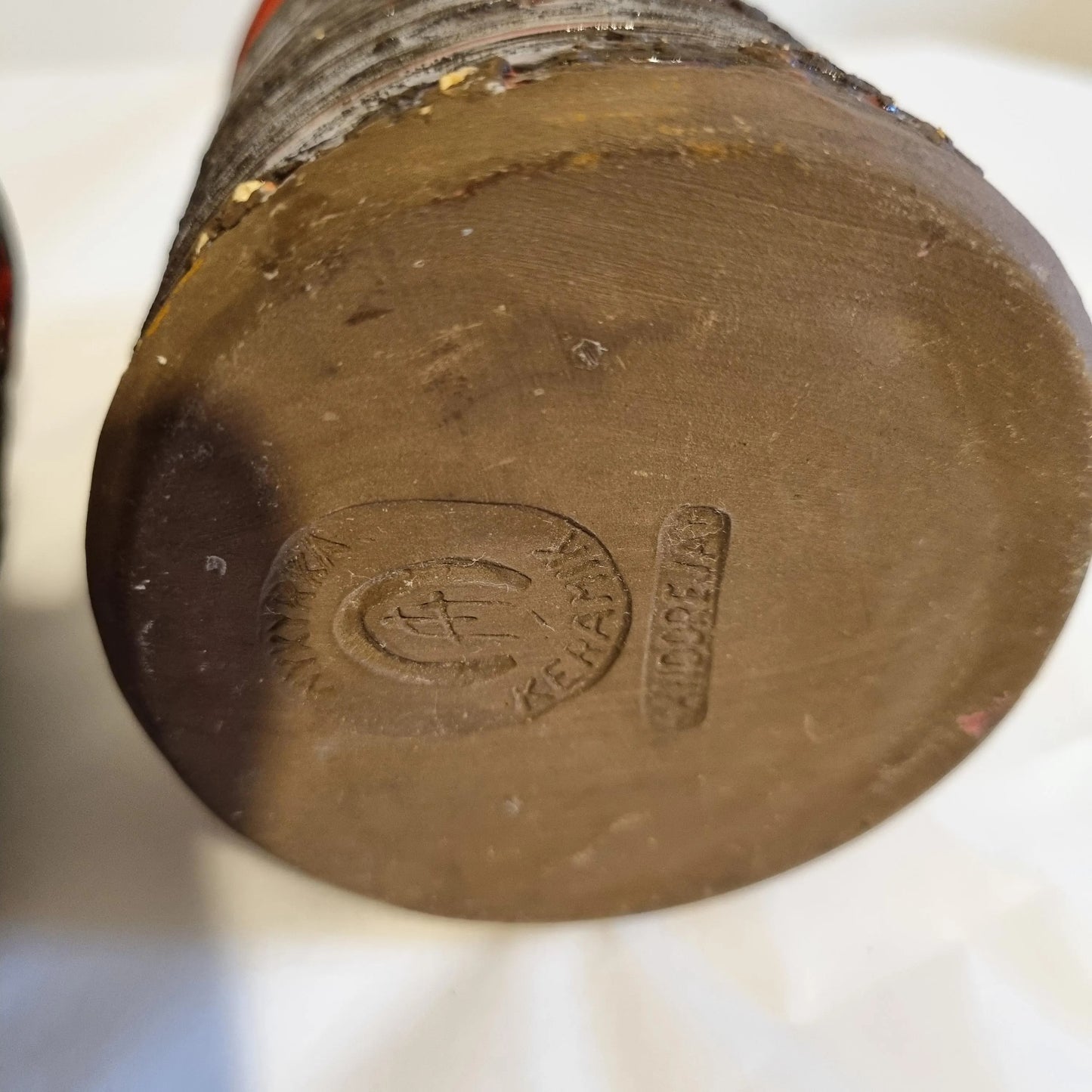 Base of Scandinavian Ceramic Vase Set – Rustic Stoneware, Japandi Style with maker's mark and textured brown clay surface.