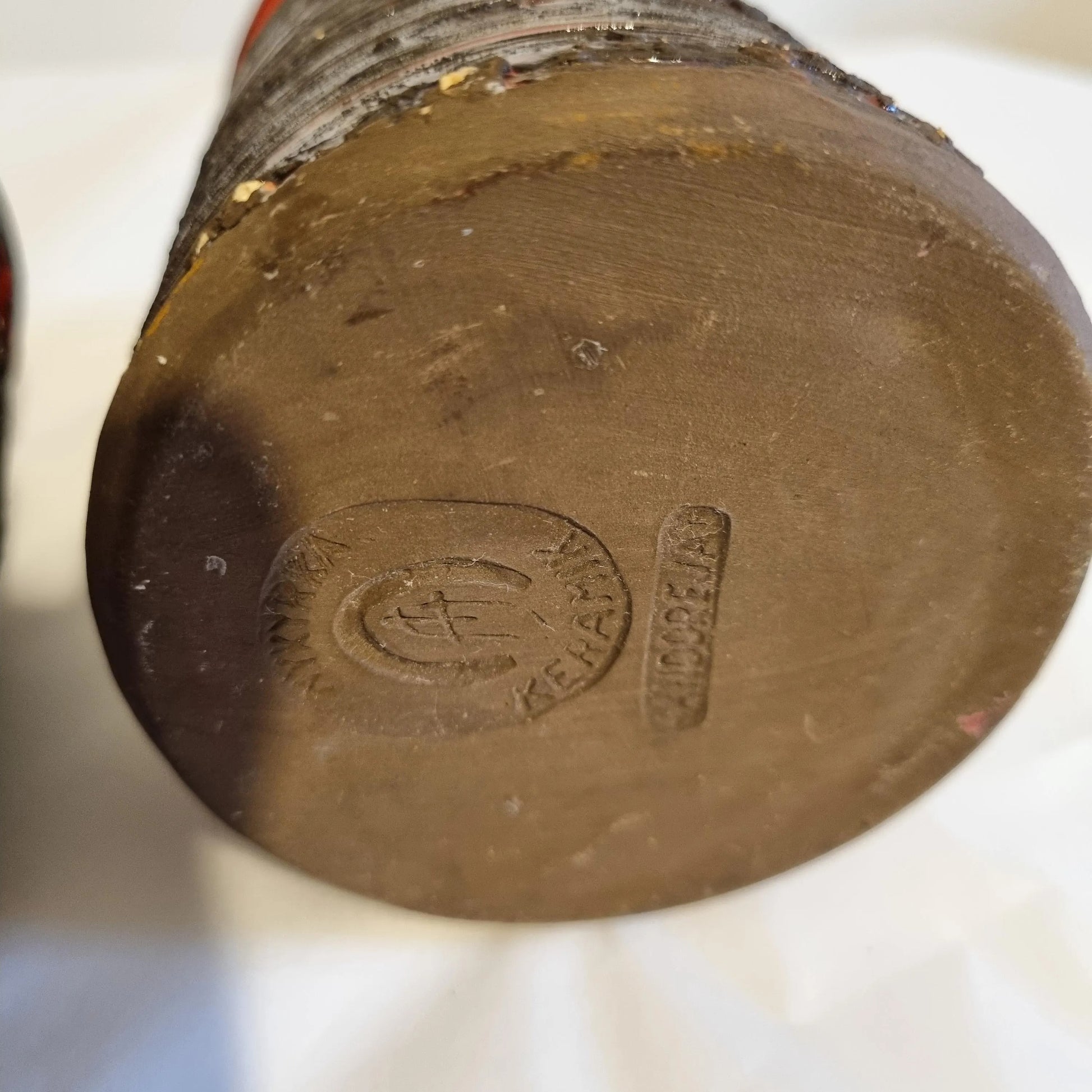Base of Scandinavian Ceramic Vase Set – Rustic Stoneware, Japandi Style with maker's mark and textured brown clay surface.