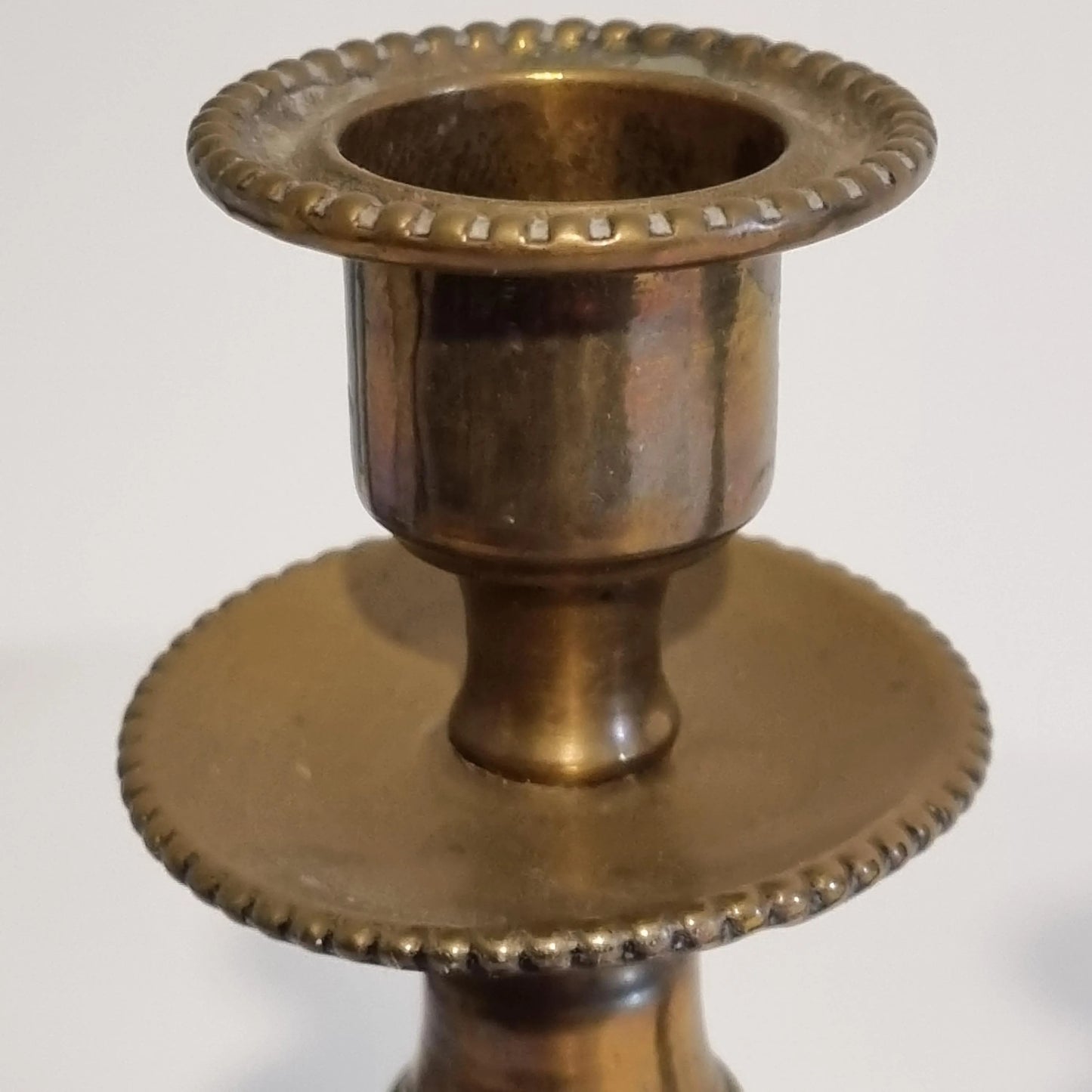 Vintage Brass Candle Holders: Hand-Painted European Village Scene, 1920s Pair showing detailed brass top with beaded edges