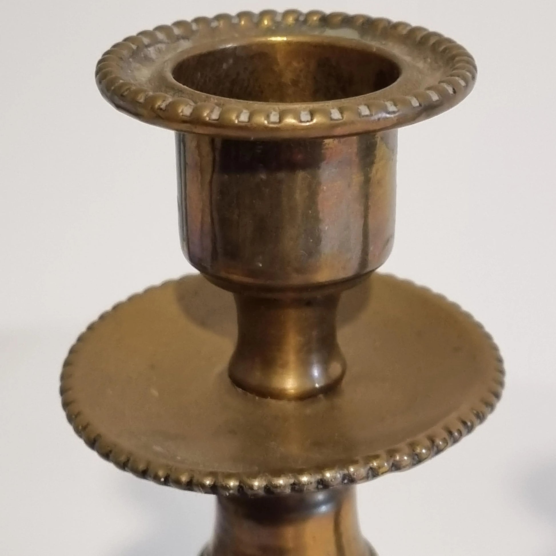 Vintage Brass Candle Holders: Hand-Painted European Village Scene, 1920s Pair showing detailed brass top with beaded edges